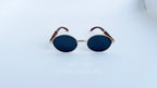 Ochelari de soare Cartier Giverny Style cu rame aurii și maro și lentile negre, design oval elegant.