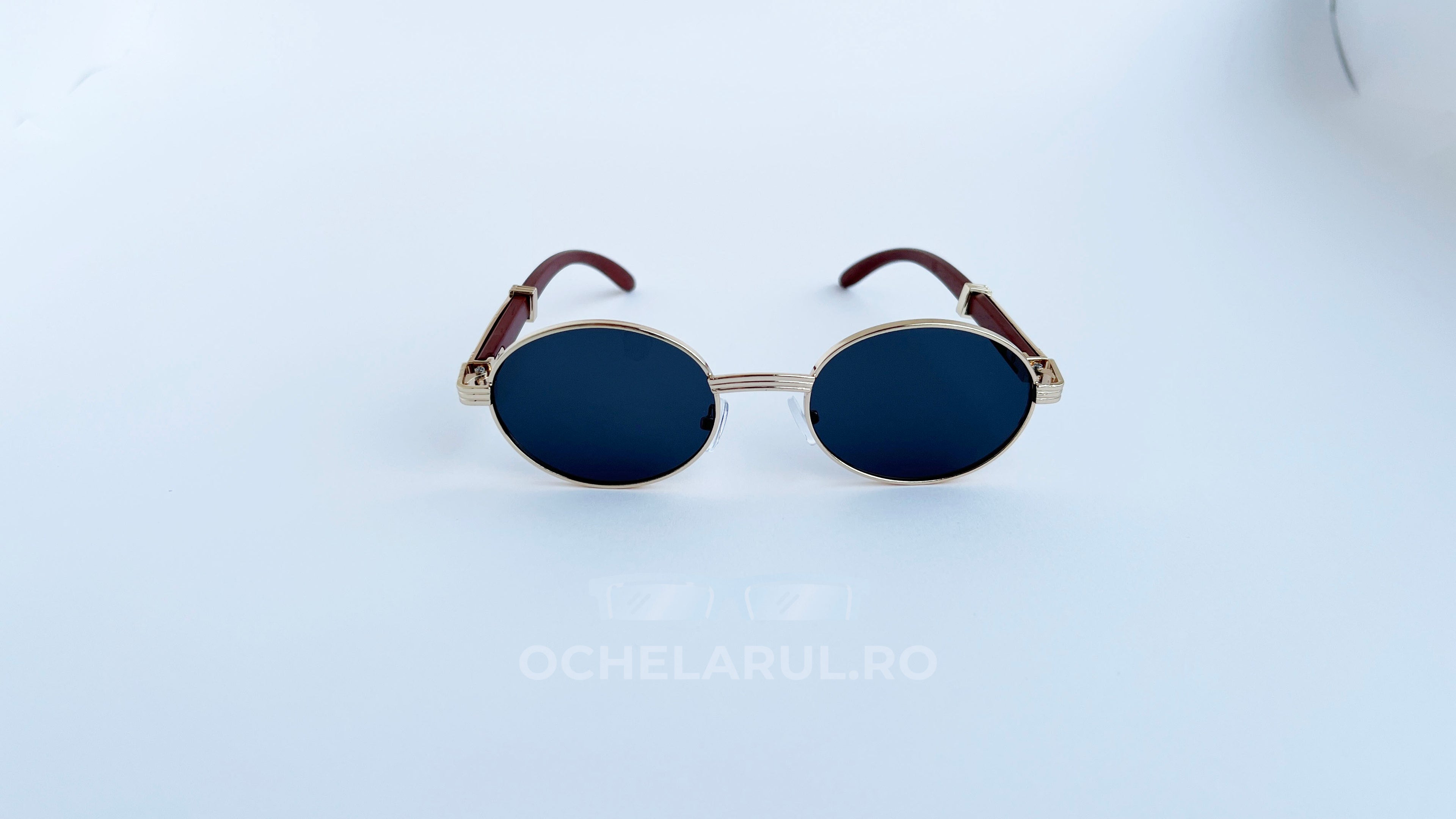 Ochelari de soare Cartier Giverny Style cu rame aurii și maro și lentile negre, design oval elegant.
