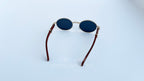 Ochelari de soare Cartier Giverny Style cu rame aurii și brațe maro, lentile negre ovale, design elegant.