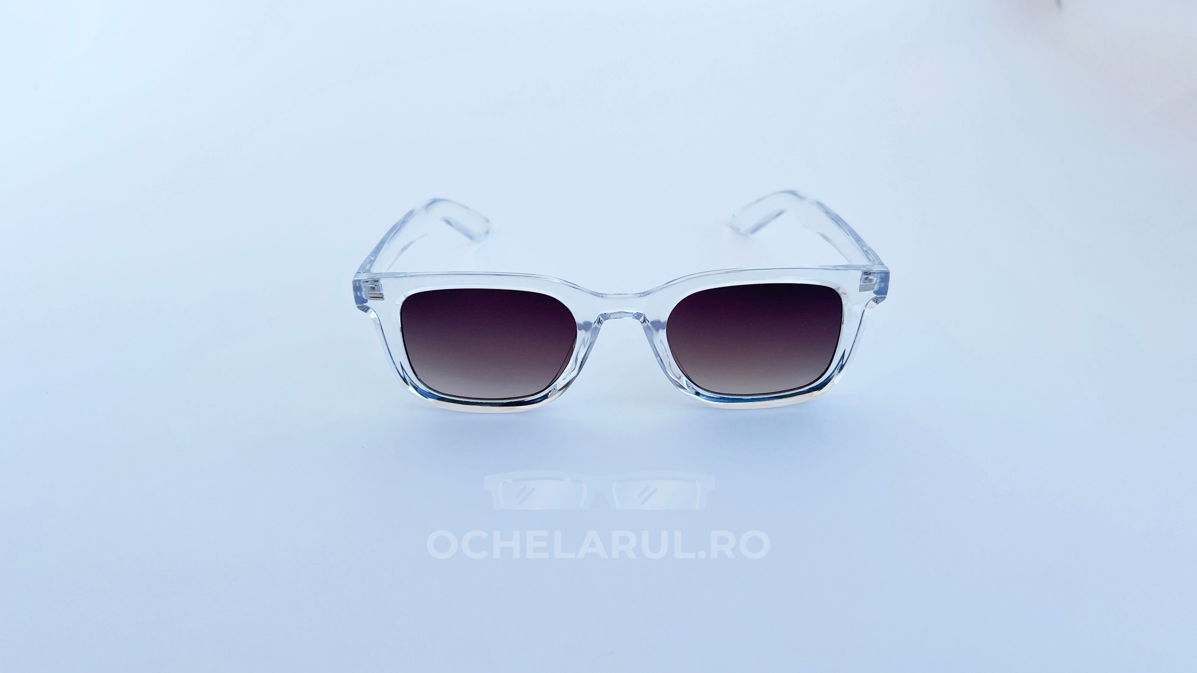 Ochelari de soare Moscot Klutz Style cu rame transparente și lentile maro degrade, unisex, pentru protecție UV și stil modern.