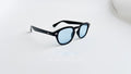 Ochelari de soare Moscot Lemtosh Style cu rame negre și lentile albastre, design elegant pentru bărbați.