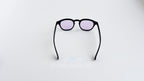 Ochelari de soare Moscot Lemtosh Style cu rame negre și lentile mov, model unisex modern pentru protecție solară.
