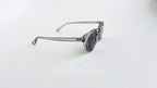 Ochelari de soare Oliver Peoples Style cu rame transparente gri și lentile gri, design modern pentru bărbați.