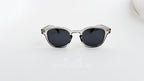 Ochelari de soare Moscot Lemtosh Style cu rame gri transparente și lentile negre pentru protecție UV.