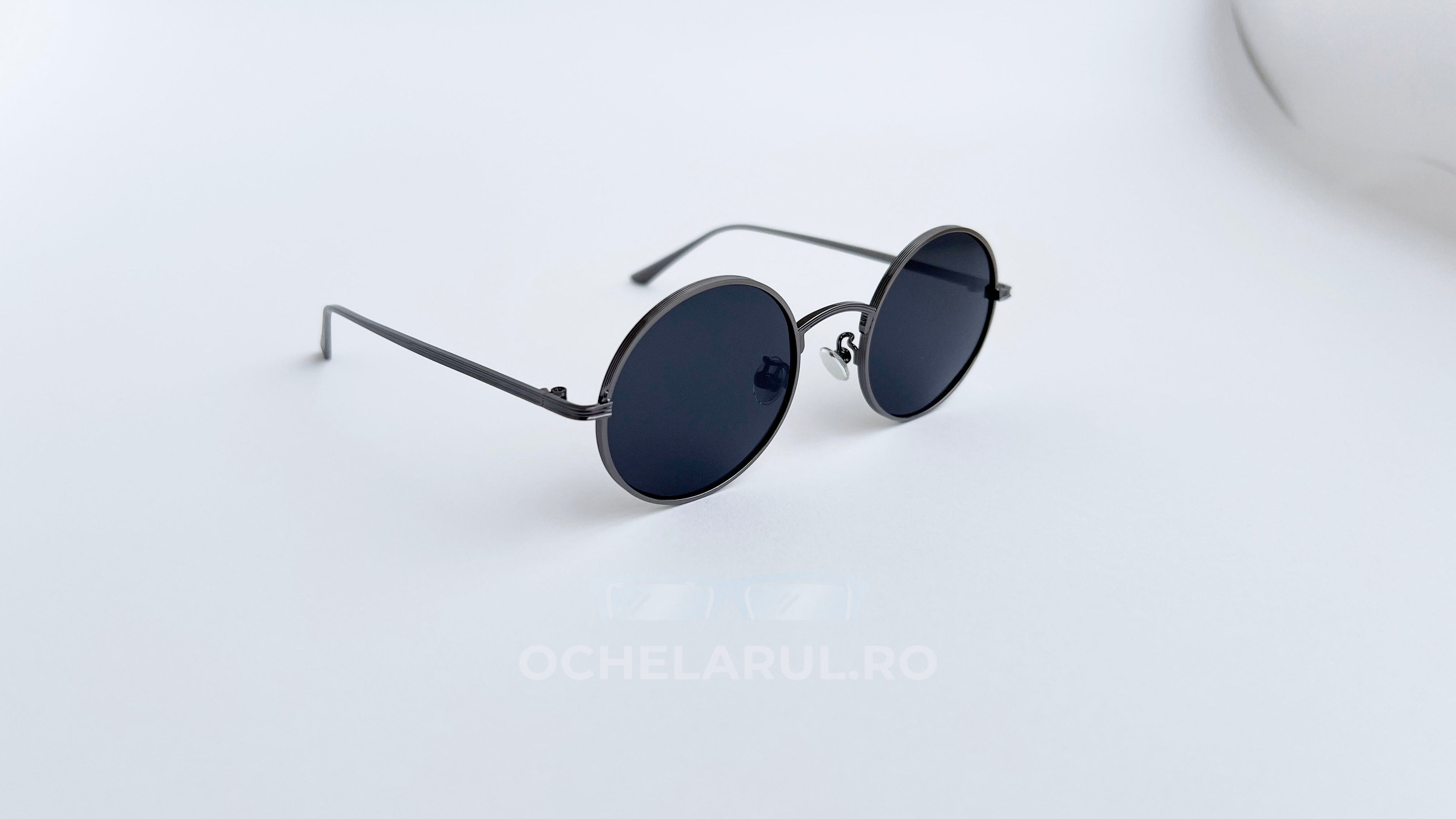 Ochelari de soare Rotunzi cu rame subțiri gri și lentile negre polarizate, design minimalist și elegant, potriviți pentru bărbați ce caută stil și protecție UV.