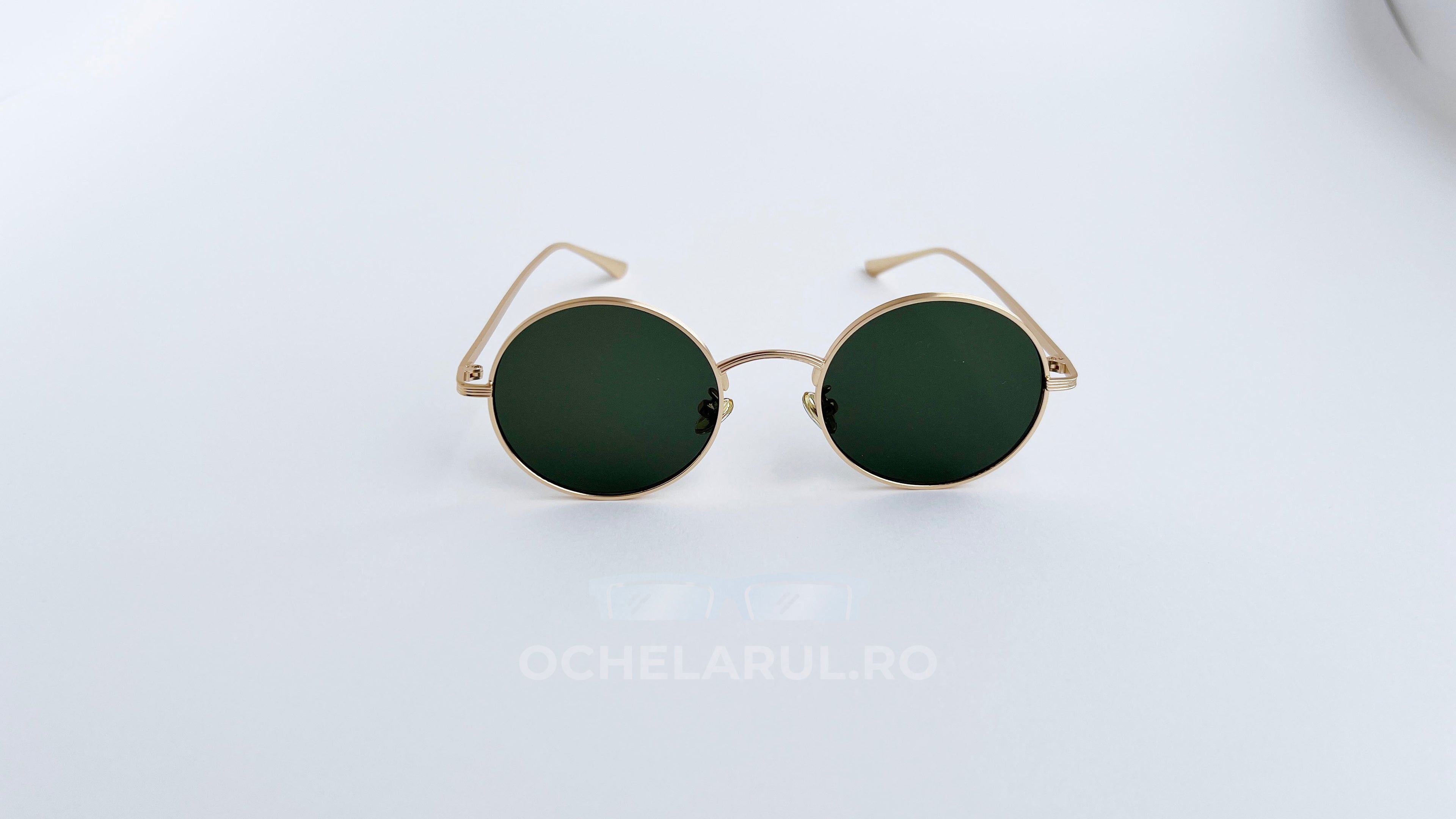 Ochelari de soare Rotunzi cu rame aurii și lentile verzi, eleganți și moderni pentru protecție solară.
