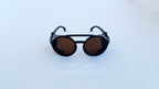 Ochelari de soare Steampunk Rotunzi cu rame negre și lentile maro, model unisex pentru protecție solară și stil distinctiv.