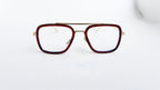 Ochelari Dita Flight Style cu rame maro și aurii, lentile transparente, design modern pentru bărbați.