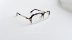 Rame ochelari Cazal 6034 Style în nuanțe de auriu și maro, cu lentile transparente și design modern.