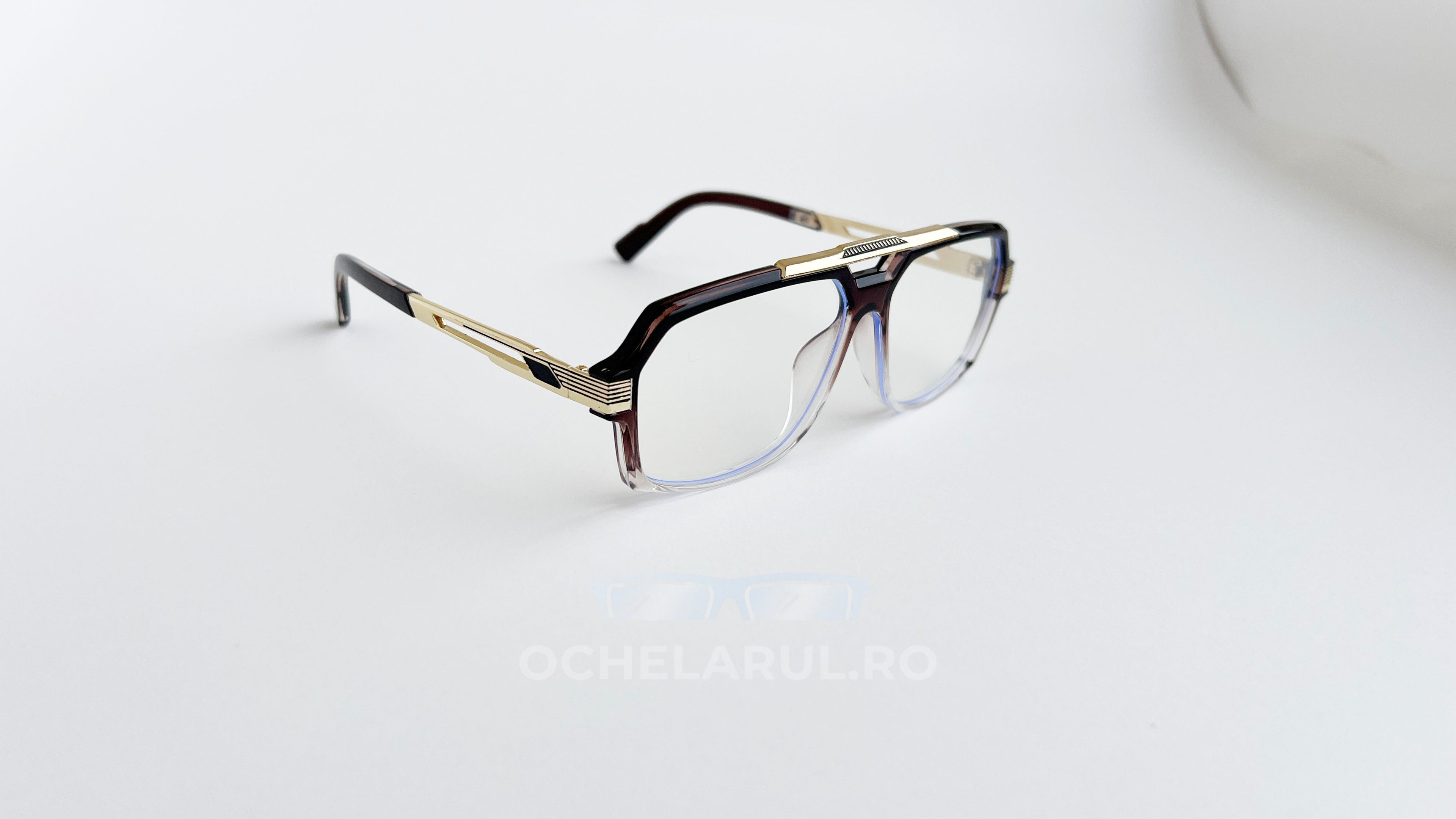 Rame ochelari Cazal 6034 Style în nuanțe de auriu și maro, cu lentile transparente și design modern.
