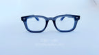 Rame ochelari Moscot Klutz Style cu design dreptunghiular și lentile transparente, cadran albastru închis.