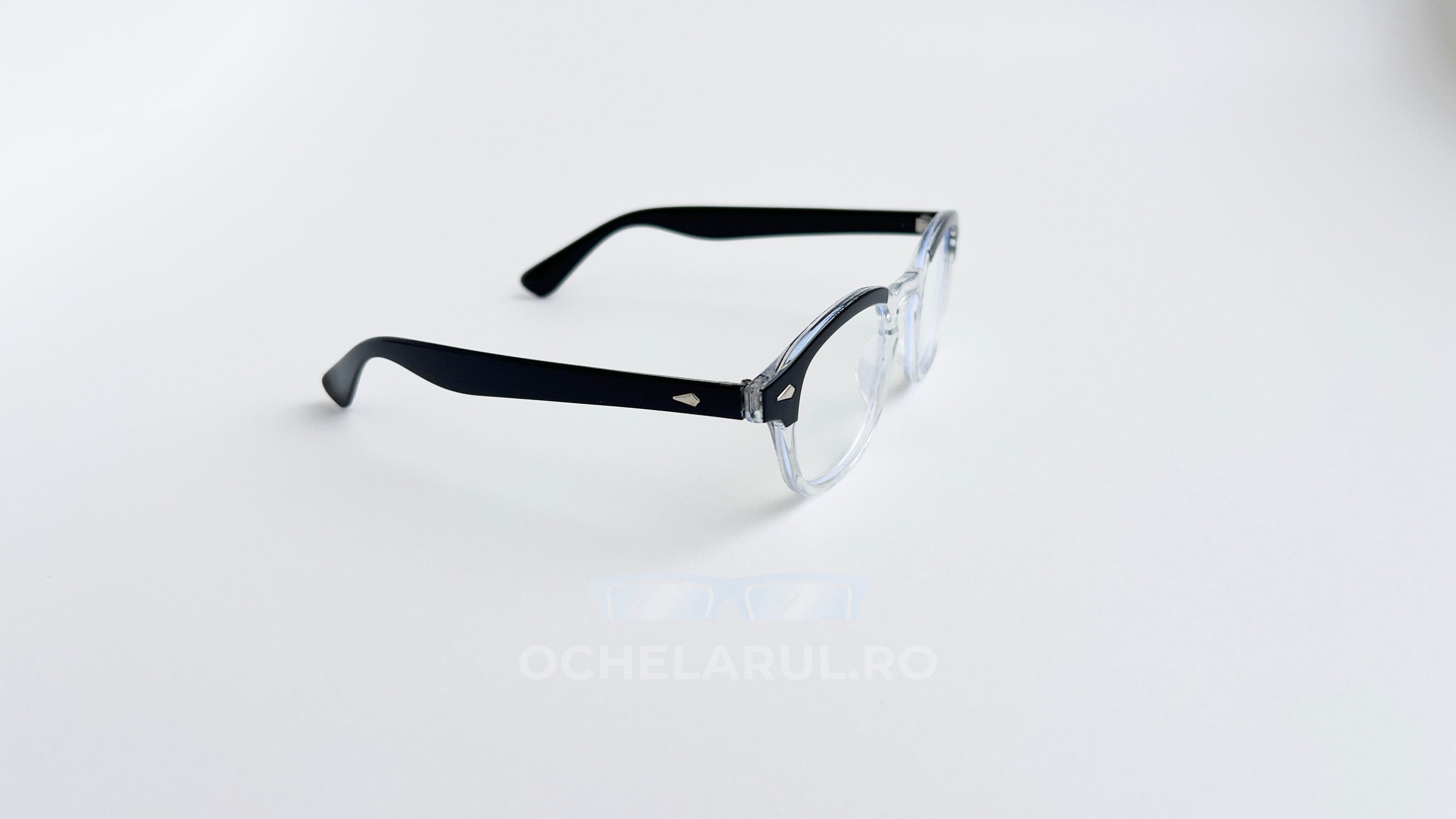 Rame ochelari Moscot Lemtosh Style cu lentile transparente și brațe negre, design clasic și elegant.