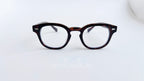 Rame ochelari Moscot Style cu lentile transparente și cadru în nuanțe de tortoise, stil clasic masculin.