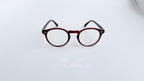 Rame ochelari Oliver Peoples Style cu design rotund și culoare maro degrade, lentile transparente elegante.