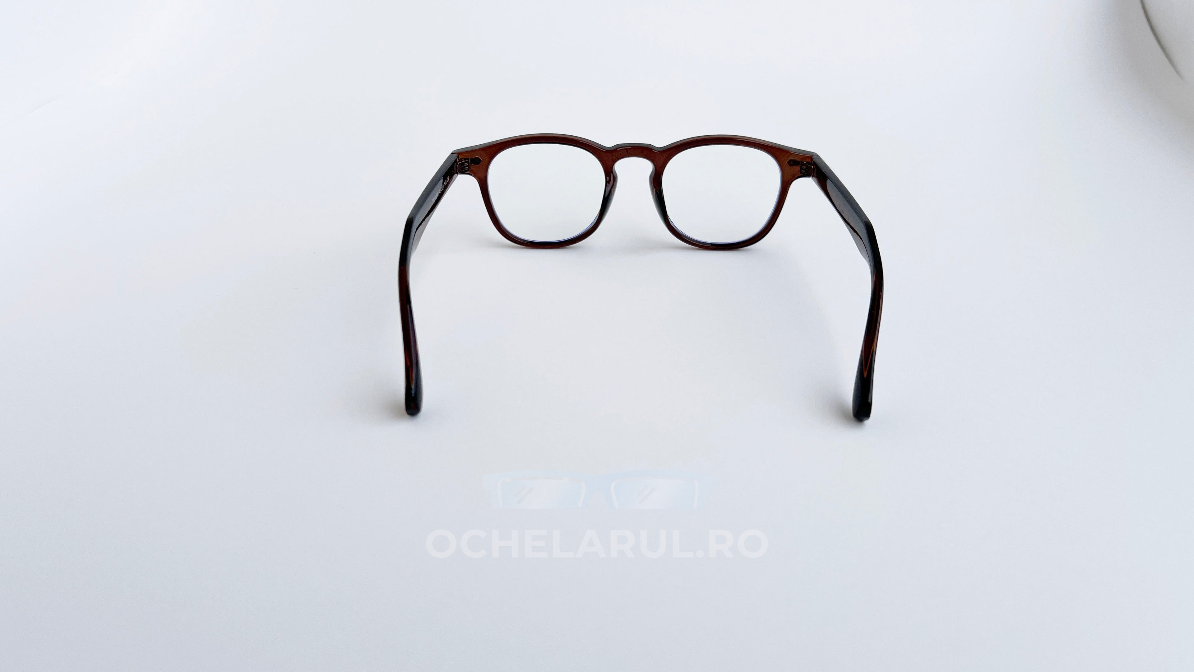 Rame ochelari Pătrate Moscot Style maro transparent din material rezistent cu lentile transparente, prezentate pe fundal alb.