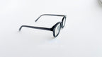 Rame ochelari Ovale Vintage cu lentile transparente și design clasic, din material gri închis.